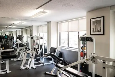 a gym with several tread machines in a room at Blueground Downtown Brooklyn rooftop nr Brooklyn Bridge NYC-2125 in Brooklyn