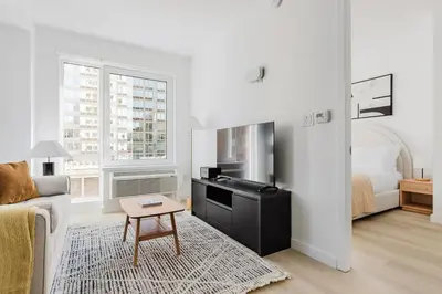 a living room with a couch and a table at Blueground Downtown Brooklyn rooftop nr Brooklyn Bridge NYC-2125 in Brooklyn