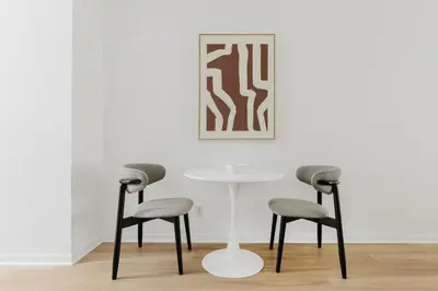 two chairs and a table in front of a white wall at Blueground Alphabet City washer nr Tompkins Square Park NYC-2160 in New York