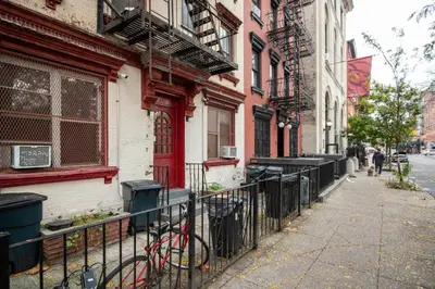 a bike leaning against a fence next to a building at Blueground Alphabet City washer nr Tompkins Square Park NYC-2160 in New York