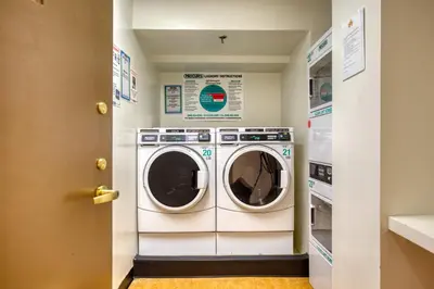a laundry room with a washer and dryer at Blueground Upper West Side fitness nr Central Park NYC-1993 in New York