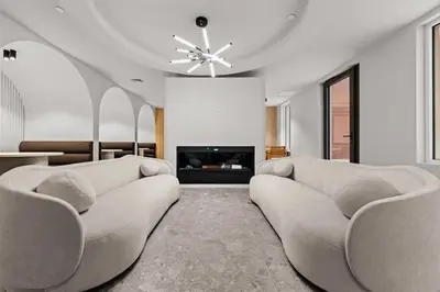 a living room with two couches and a fireplace at Blueground Long Island City fitness center nr Gantry Plaza State Park NYC-2181 in New York