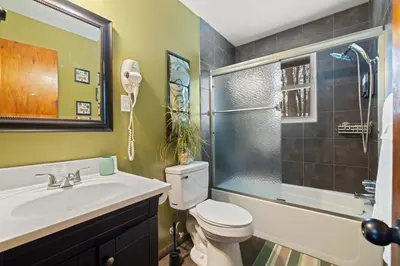 a bathroom with a sink and a toilet and a shower at Hot Tub + Fire Pit • Game Room • Community Pool in Tobyhanna
