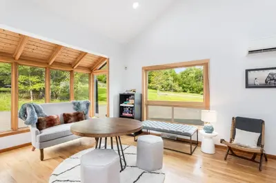 a living room with a table and a couch at 5 Minutes to Ski Hunter Mountain! Family Friendly - Hot Tub, Sauna, Sunset Views in Hunter