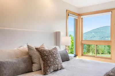 a bedroom with a bed with a large window at 5 Minutes to Ski Hunter Mountain! Family Friendly - Hot Tub, Sauna, Sunset Views in Hunter