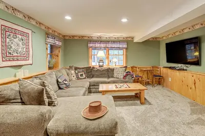 a living room with a couch and a table at On-Site Pond and Trails Lake Luzerne Cabin in Lake Luzerne