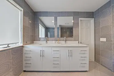 a bathroom with a white sink and a mirror at Family Staycation Retreat 7BDR Sauna Games