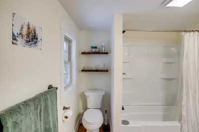 a white bathroom with a toilet and a shower at 5 Mi to Mt Snow Secluded Family Home with Game Area in West Dover