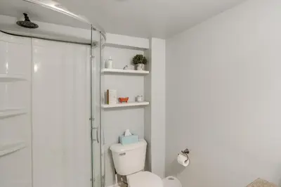 a bathroom with a toilet and a glass shower at 5 Mi to Mt Snow Secluded Family Home with Game Area in West Dover