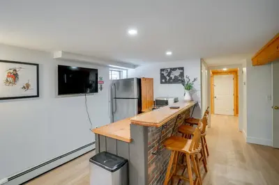 a kitchen with a counter and a refrigerator at 5 Mi to Mt Snow Secluded Family Home with Game Area in West Dover