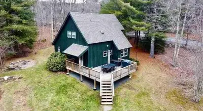 an aerial view of a green house with a deck at Cozy Winter Retreat Minutes from Hunter Mountain in Jewett