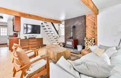 a living room with a couch and a fireplace at Cozy Winter Retreat Minutes from Hunter Mountain in Jewett