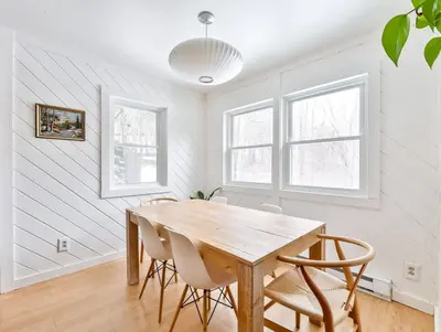 a dining room with a wooden table and chairs at Cozy Winter Retreat Minutes from Hunter Mountain in Jewett