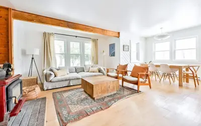 a living room with a couch and a table at Cozy Winter Retreat Minutes from Hunter Mountain in Jewett