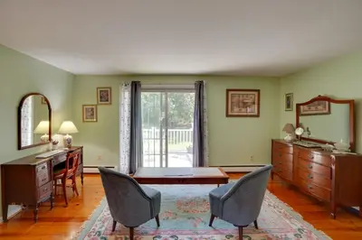 a living room with a desk and a table and chairs at Cozy Pittsfield Gem with Deck, Gazebo and Fireplace in Pittsfield