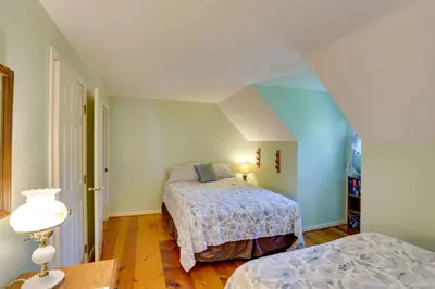 a bedroom with two beds in a attic at Cozy Pittsfield Gem with Deck, Gazebo and Fireplace in Pittsfield