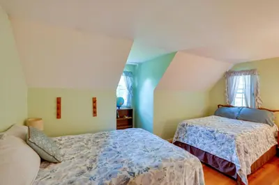 a bedroom with two beds and a window at Cozy Pittsfield Gem with Deck, Gazebo and Fireplace in Pittsfield