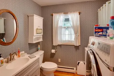 a bathroom with a sink and a toilet and a microwave at Cozy Pittsfield Gem with Deck, Gazebo and Fireplace in Pittsfield