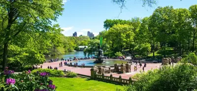 people walking around a fountain in a park next to a river at New2 York Stylish 2BR Apartment in Manhattan in New York