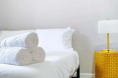 a pile of towels sitting on top of a bed at New2 York Stylish 2BR Apartment in Manhattan in New York