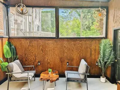 a room with two chairs and a table and windows at Family-Friendly 2BR, NYC Access in Minutes in Hoboken