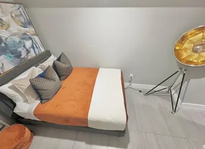 a bedroom with a bed and a table in it at Large 4 Bedroom NYC Property in Mott Haven