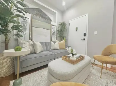 a living room with a couch and a table at Large 4 Bedroom NYC Property in Mott Haven