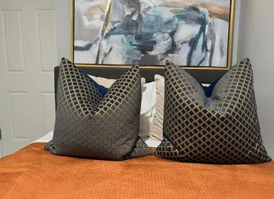 two pillows sitting on top of a bed with a painting at Large 4 Bedroom NYC Property in Mott Haven