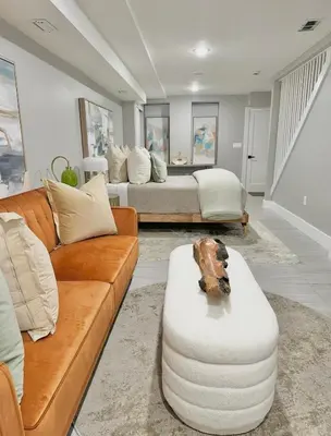 a living room with a couch and a table at Large 4 Bedroom NYC Property in Mott Haven