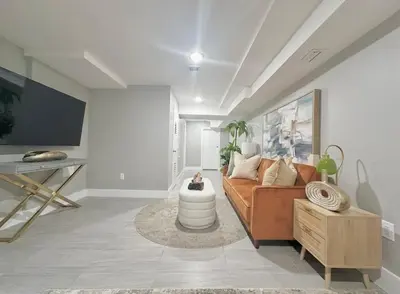 a living room with a couch and a table at Large 4 Bedroom NYC Property in Mott Haven