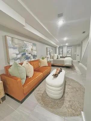 a living room with a couch and a table at Large 4 Bedroom NYC Property in Mott Haven