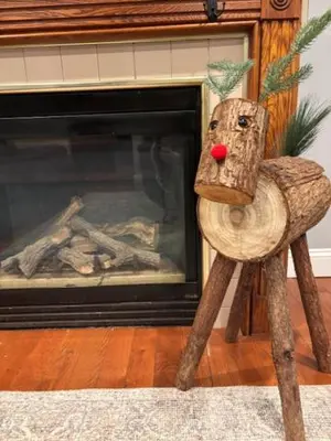 a wooden reindeer standing in front of a fireplace at Lakeview Family Retreat Newly Renovated 4BR House in Pocono Country Place