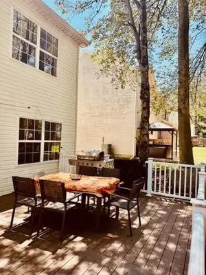 a patio with a table and chairs in front of a house at Lakeview Family Retreat Newly Renovated 4BR House in Pocono Country Place