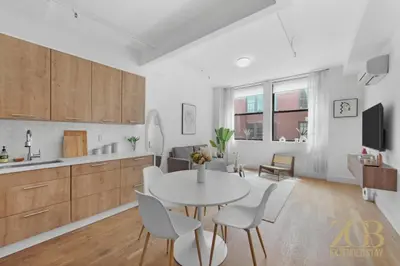a kitchen and living room with a table and chairs at 517 - 47C Beautifully Renovated 1 bedroom in Prime Manhattan in New York