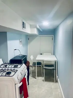 a kitchen with a stove and a table and a stove top at Cozy Home 422 South 16th street in Newark