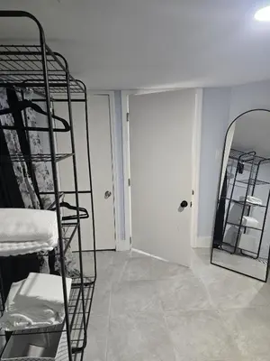 a room with two bunk beds and a mirror at Cozy Home 422 South 16th street in Newark