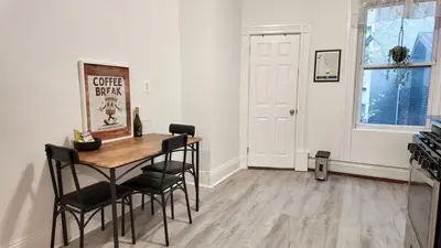 a dining room with a table and chairs in a room at A Luxury Apartment in the Heart of Hoboken in Hoboken