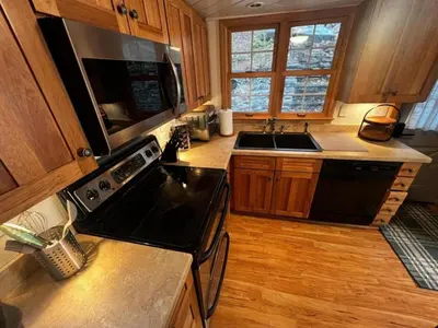 a kitchen with a black stove and a sink at Lakefront Paradise near everything! in Hawley