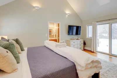 a bedroom with a large bed and a window at 8 Mi to Saratoga Race Course Quiet Family Home in Saratoga Springs