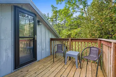 a patio with two chairs and a table on a deck at 8 Mi to Saratoga Race Course Quiet Family Home in Saratoga Springs