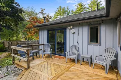 a deck with chairs and a picnic table on a house at 8 Mi to Saratoga Race Course Quiet Family Home in Saratoga Springs