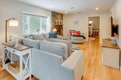a living room with a couch and a table at 8 Mi to Saratoga Race Course Quiet Family Home in Saratoga Springs
