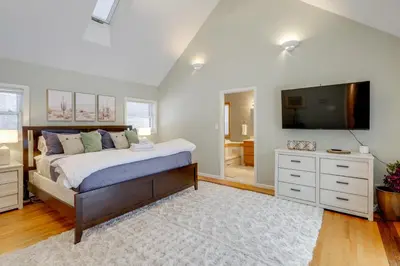 a bedroom with a large bed and a television at 8 Mi to Saratoga Race Course Quiet Family Home in Saratoga Springs