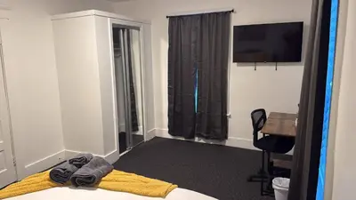 a room with a bed and a desk and a television at Nona - Private Room 1 with Parking, Desk & Fast WiFi near Yale, Quinnipiac, SCSU & Hospitals in Hamden