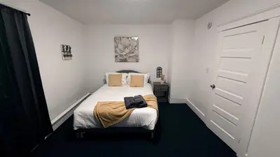 a small bedroom with a bed and a door at Nona - Private Room 1 with Parking, Desk & Fast WiFi near Yale, Quinnipiac, SCSU & Hospitals in Hamden
