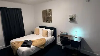 a small bedroom with a bed and a desk at Nona - Private Room 2 with Parking, Desk & Fast WiFi near Yale, Quinnipiac, SCSU & Hospitals in Hamden