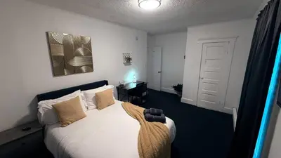 a bedroom with a bed with white sheets and pillows at Nona - Private Room 2 with Parking, Desk & Fast WiFi near Yale, Quinnipiac, SCSU & Hospitals in Hamden