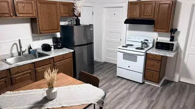 a kitchen with a refrigerator and a stove and a table at Nona - Private Room 3 with Parking, Desk & Fast WiFi near Yale, Quinnipiac, SCSU & Hospitals in Hamden