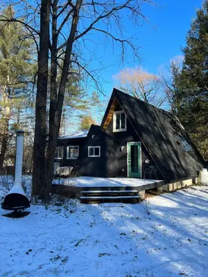 a house in the snow in front at Modern A-Frame Cabin with Loft, Firepit and Grill in Catskill