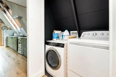 a laundry room with a washer and dryer at Modern A-Frame Cabin with Loft, Firepit and Grill in Catskill